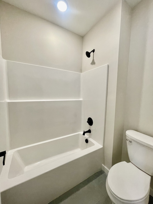 bathroom featuring tile patterned flooring, bathtub / shower combination, and toilet