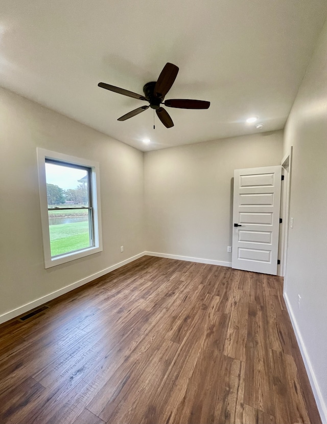 unfurnished room featuring dark hardwood / wood-style floors and ceiling fan