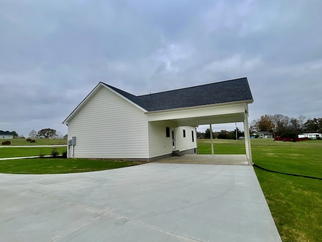 view of side of property featuring a yard and a carport