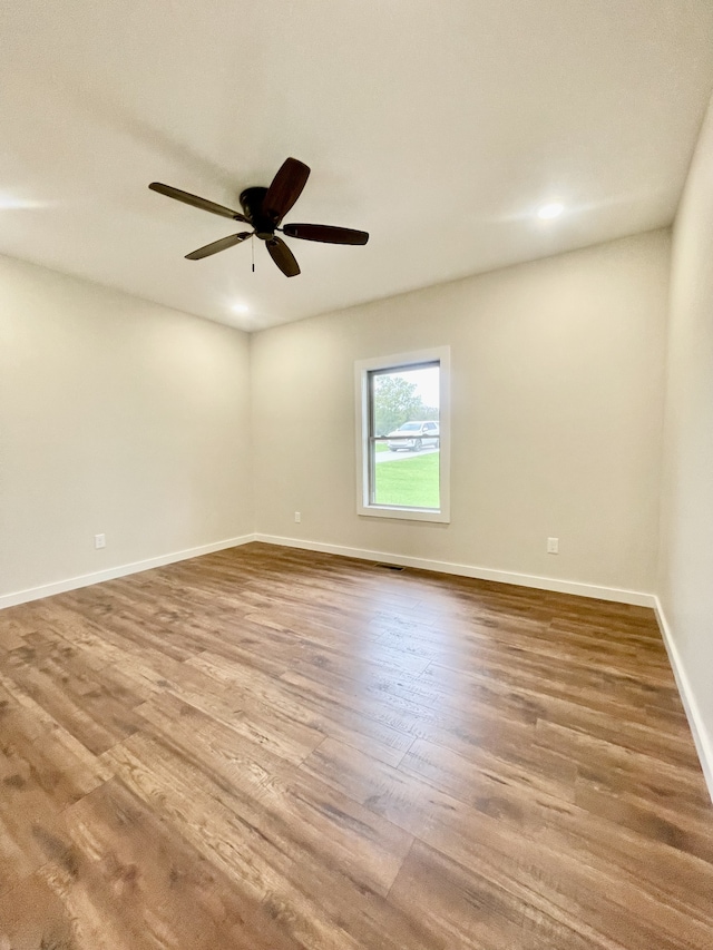 spare room with ceiling fan and hardwood / wood-style flooring