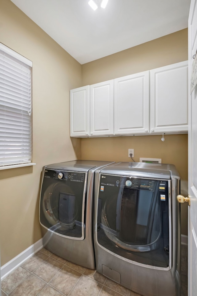 washroom featuring light tile patterned floors, cabinets, and independent washer and dryer