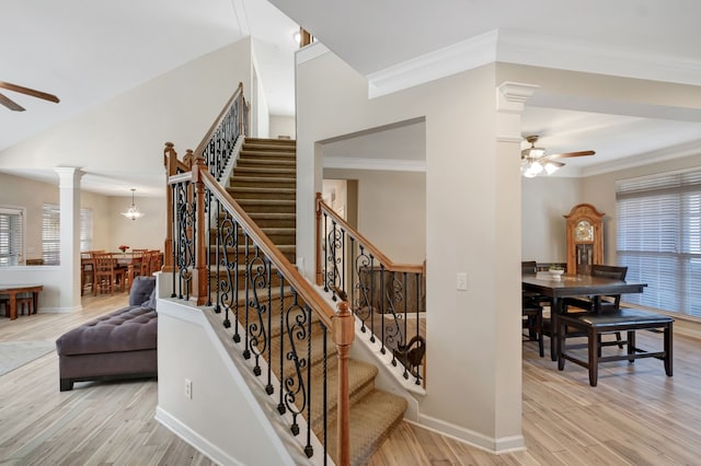 staircase with hardwood / wood-style floors, decorative columns, plenty of natural light, and ceiling fan