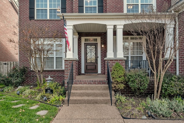 view of exterior entry with covered porch