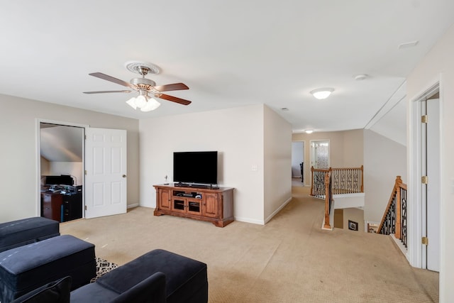 carpeted living room with ceiling fan