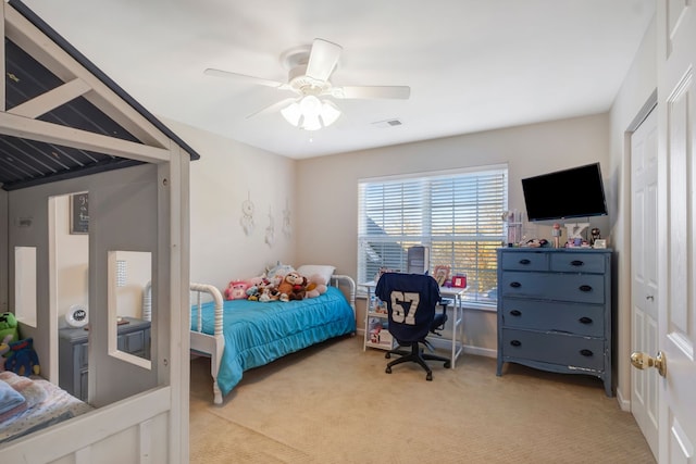 bedroom with ceiling fan and light carpet