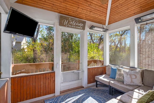 sunroom with plenty of natural light, wooden ceiling, and lofted ceiling