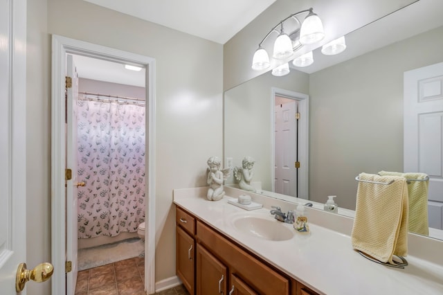 bathroom with tile patterned floors, curtained shower, vanity, and toilet