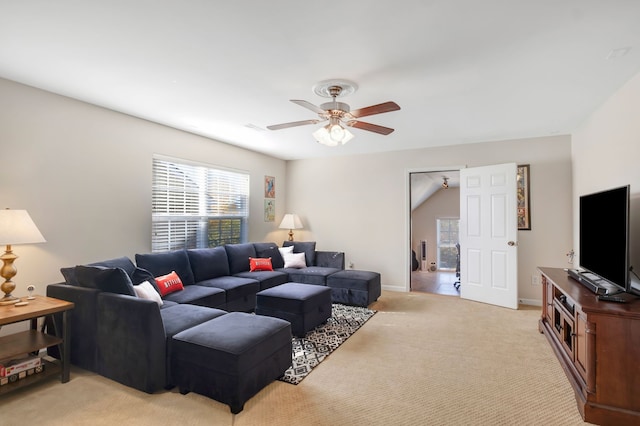 carpeted living room featuring ceiling fan