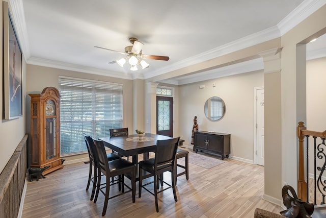 dining area featuring light wood-type flooring, decorative columns, ceiling fan, and ornamental molding