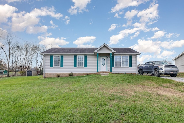 view of front of home with a front lawn and a storage unit