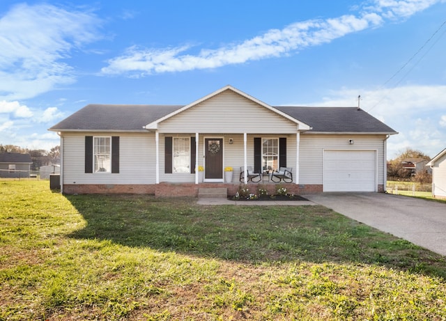 single story home featuring a front yard, a porch, and a garage