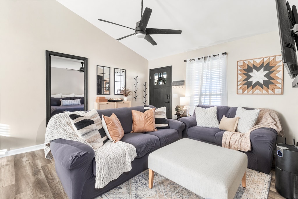 living room with light wood-type flooring and lofted ceiling