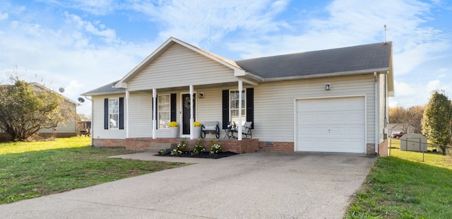 view of front of house featuring covered porch, a garage, and a front yard