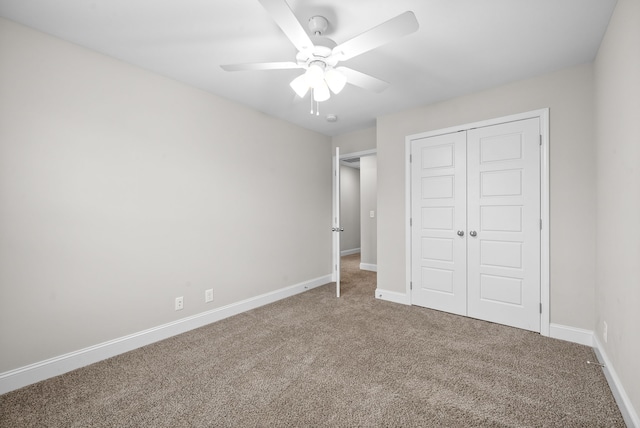 unfurnished bedroom featuring carpet, a closet, and ceiling fan