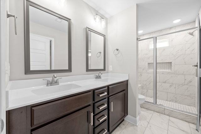 bathroom featuring vanity, toilet, and an enclosed shower