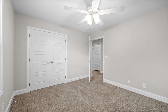 unfurnished bedroom featuring ceiling fan, a closet, and carpet floors