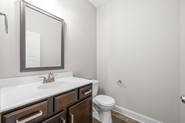 bathroom with tile patterned flooring, vanity, and toilet