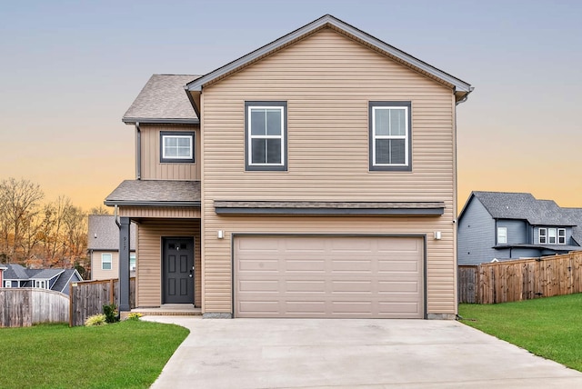 view of property with a lawn and a garage