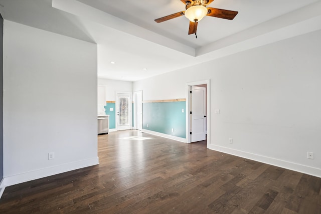 empty room with ceiling fan and dark hardwood / wood-style flooring