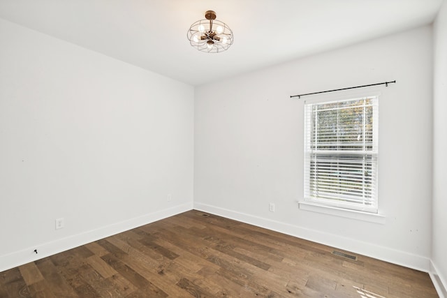 empty room featuring dark hardwood / wood-style flooring