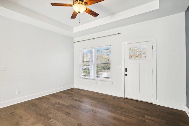 foyer entrance featuring dark hardwood / wood-style flooring, a raised ceiling, and ceiling fan