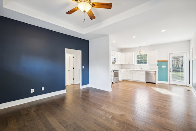 unfurnished living room with light hardwood / wood-style floors, ceiling fan, and sink