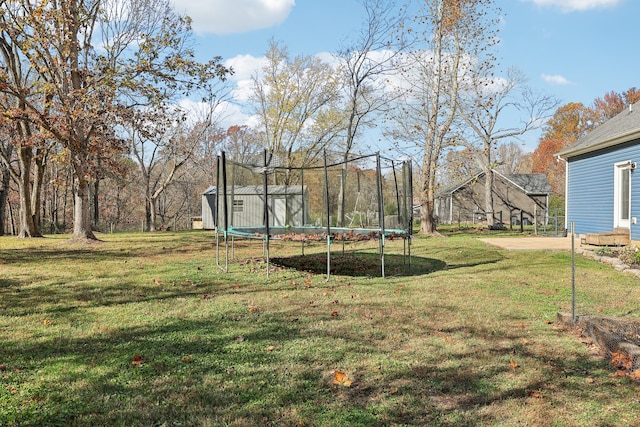 view of yard featuring a storage shed and a trampoline