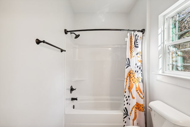 bathroom with toilet and shower / tub combo with curtain