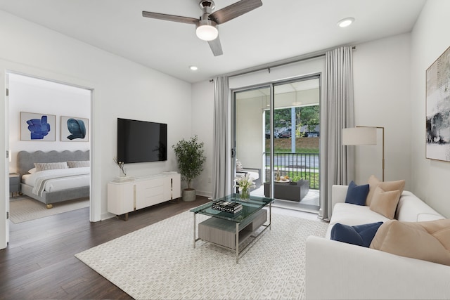 living room featuring wood-type flooring and ceiling fan