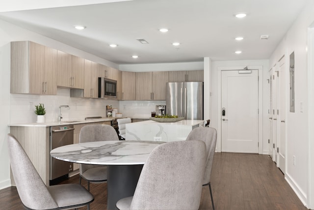 dining space featuring dark hardwood / wood-style floors and sink