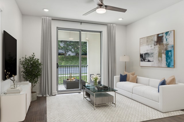 living room featuring ceiling fan, plenty of natural light, and dark hardwood / wood-style floors