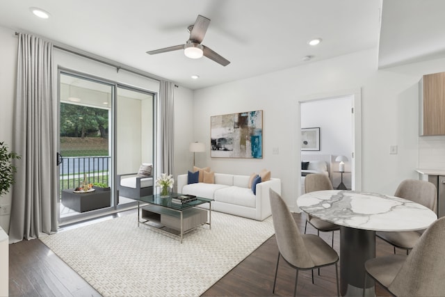 living room featuring ceiling fan and dark hardwood / wood-style flooring