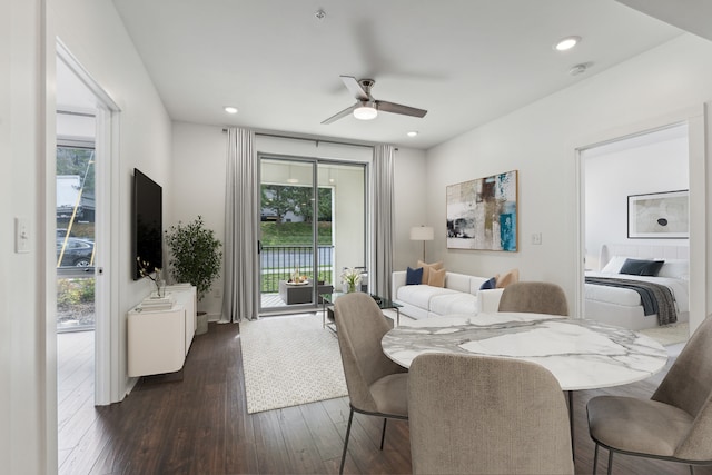 dining space with ceiling fan and dark hardwood / wood-style floors