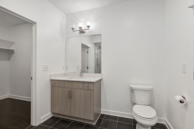 bathroom featuring tile patterned flooring, vanity, and toilet