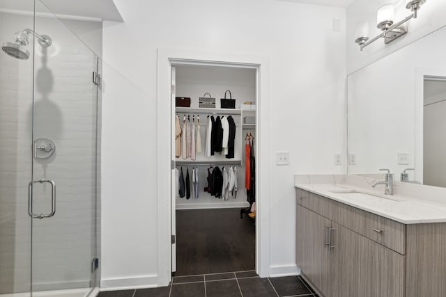 bathroom with tile patterned floors, vanity, and a shower with shower door