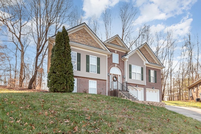 split foyer home featuring a garage and a front lawn