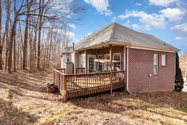 rear view of house featuring a wooden deck