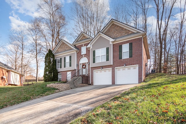 bi-level home featuring a garage and a front lawn