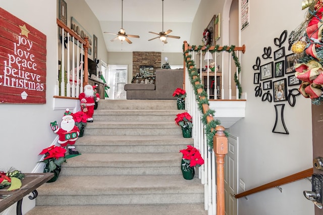 staircase with vaulted ceiling and ceiling fan