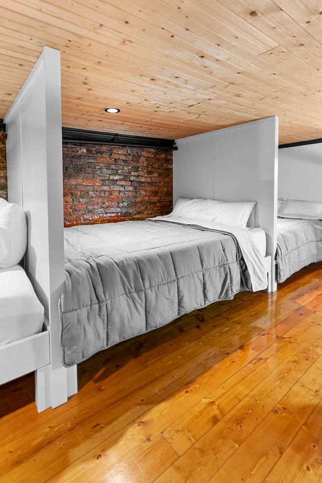 bedroom featuring wood-type flooring and wooden ceiling