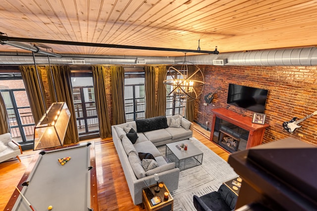 living room featuring hardwood / wood-style floors, wood ceiling, and an inviting chandelier