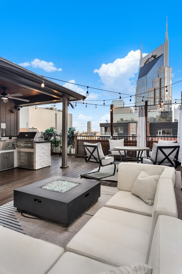 view of patio / terrace featuring area for grilling and an outdoor living space with a fire pit