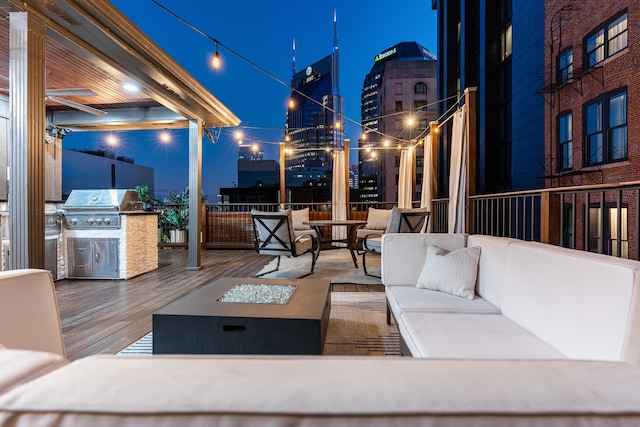 view of patio featuring area for grilling and an outdoor living space with a fire pit