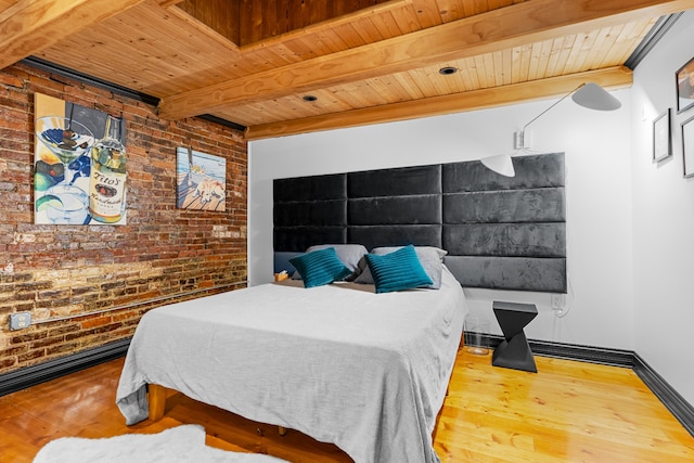 bedroom with beam ceiling, wooden ceiling, wood-type flooring, and brick wall