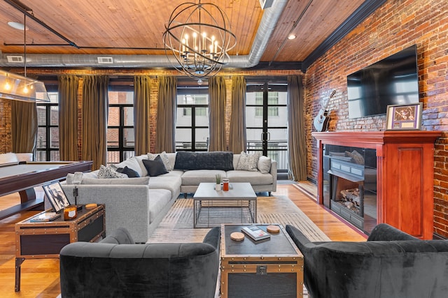 living room featuring a chandelier, wooden ceiling, brick wall, and wood-type flooring