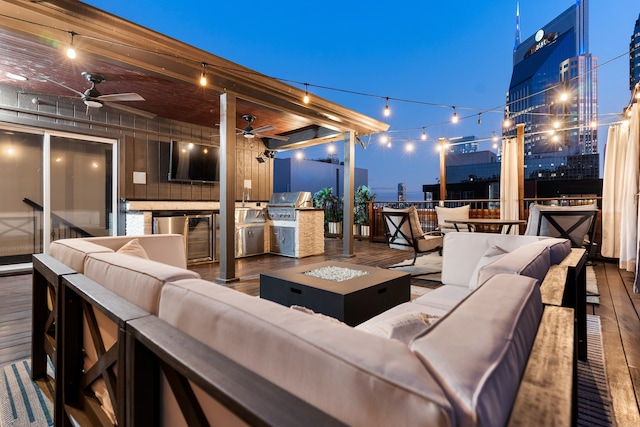 view of patio with an outdoor kitchen, area for grilling, and an outdoor living space with a fire pit