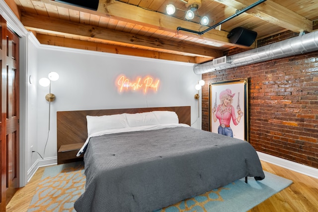 bedroom featuring beam ceiling, wooden ceiling, brick wall, crown molding, and wood-type flooring