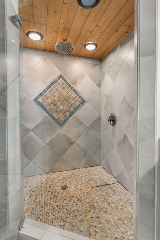 bathroom with a shower and wood ceiling