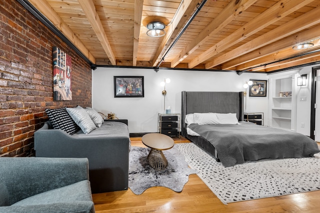 bedroom featuring beam ceiling, wooden ceiling, brick wall, and hardwood / wood-style flooring