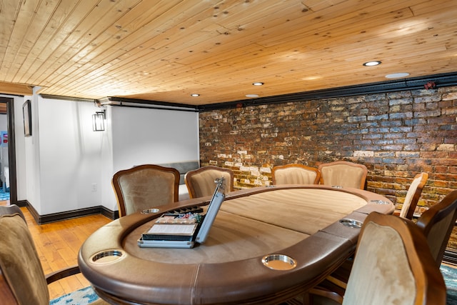 dining area with wood ceiling, brick wall, and light wood-type flooring